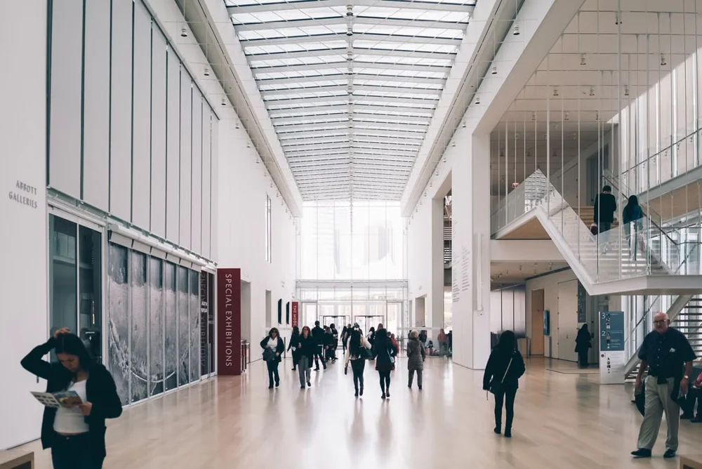 Visitors moving through a modern public community and cultural facility